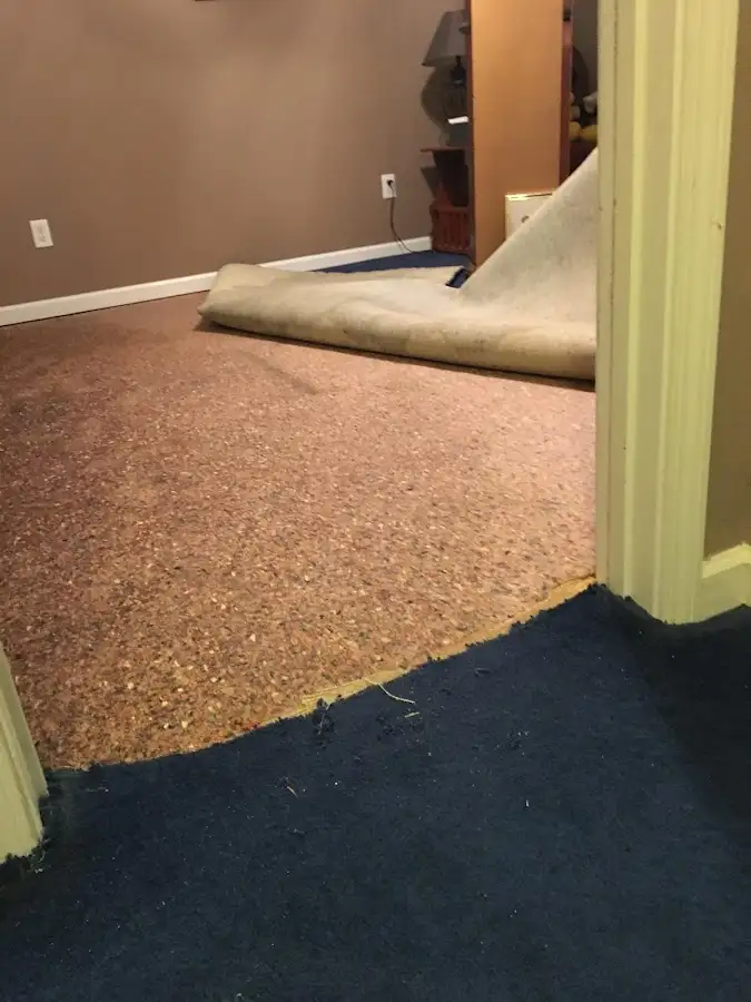Carpet pad removal revealing water damage during Water Mitigation Services in Walkersville